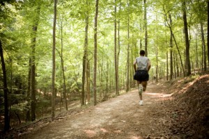 Man running in woods, rear view
